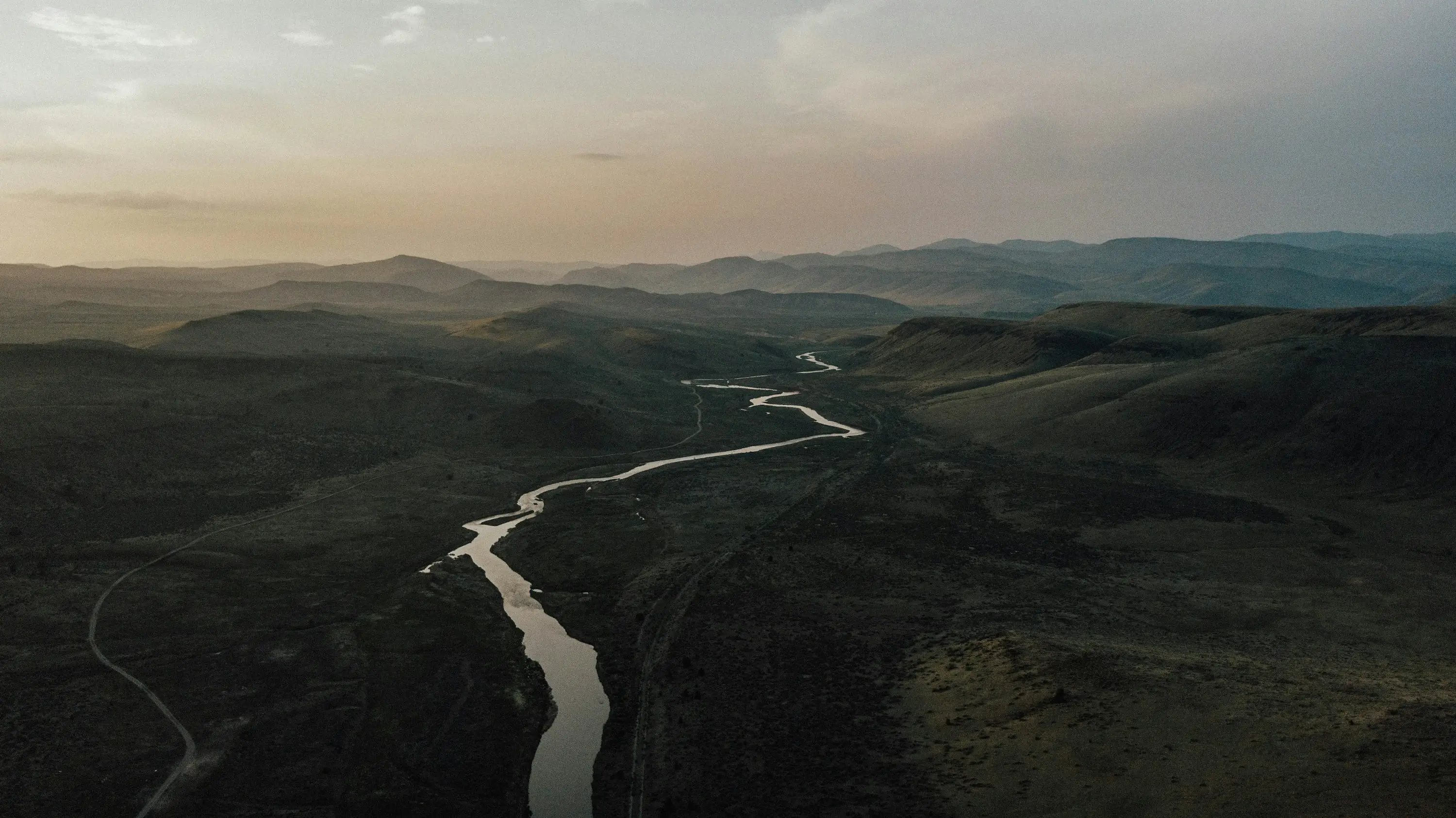 River winding through arid ranges at dusk