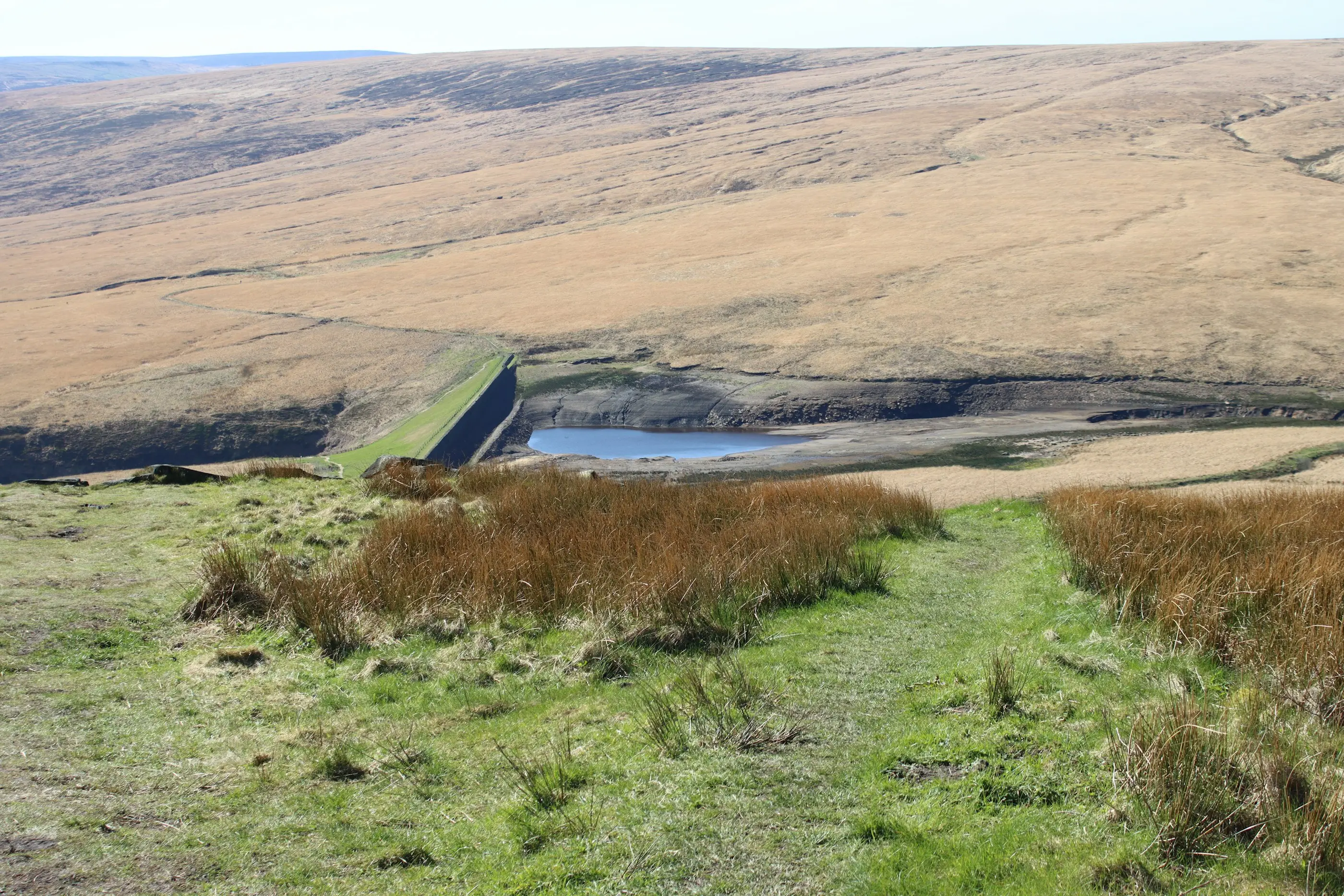 Small earth-fill dam and reservoir on open moorland